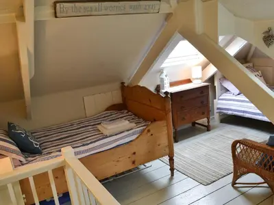 a small room with a bed and a desk at Fairmaiden in Polruan