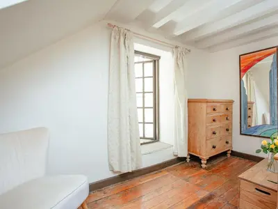 a bedroom with a bed and a dresser and a window at Alyshan in Merrymeet