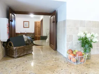 a hallway with baskets of apples and a vase of flowers at Anneth Lowen in Pentewan