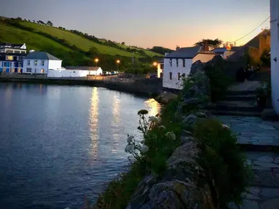 a view of a river with houses and buildings at Puffin Burrow in Portmellon