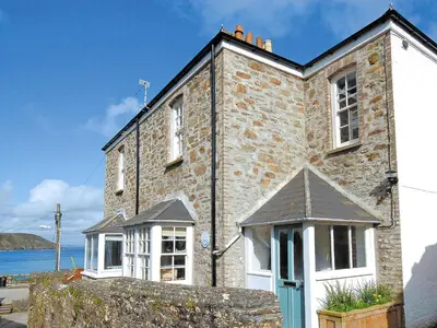 an old brick building with a blue door at The Gables in Gorran Haven