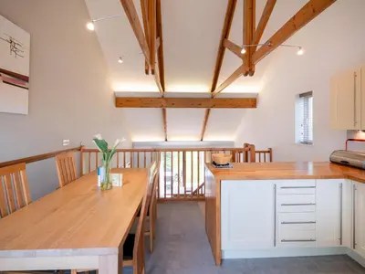 a kitchen with a wooden table and a dining room at Villa Gallery- 27073 in Perranwell
