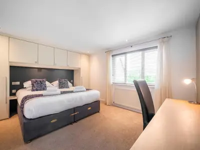 a bedroom with a large bed and a window at Villa Gallery-76 in Perranwell