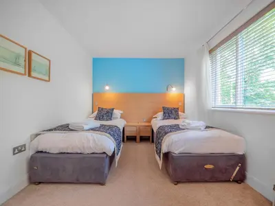 a room with two beds and a desk in it at Haven -78 in Perranwell