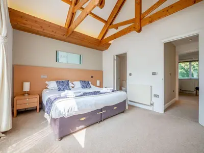 a bedroom with a large bed and a wooden ceiling at Haven -79 in Perranwell