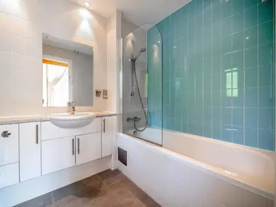 a bathroom with a sink and a tub and a shower at Haven -79 in Perranwell