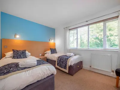 a bedroom with two beds and a window at Haven -80 in Perranwell