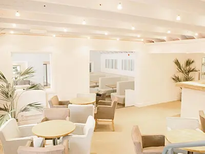 a waiting room with tables and chairs at Haven -80 in Perranwell