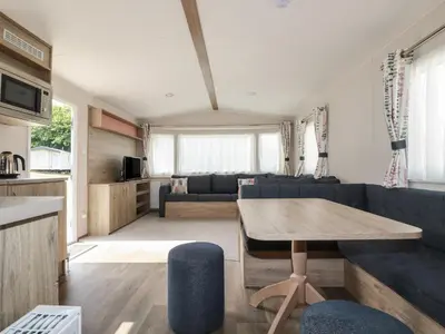 a living room with a blue couch and a table at Chez Nous in Newquay