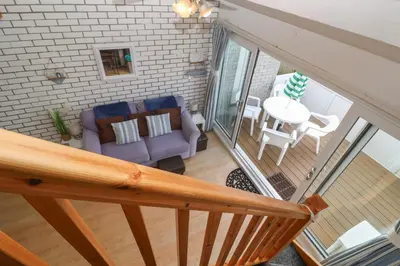 an overhead view of a living room with a couch and a table at 16 Seaspray in Truro