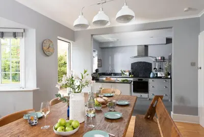 a kitchen with a wooden table with fruit on it at Mermaid Cottage, Carbis Bay in Carbis Bay