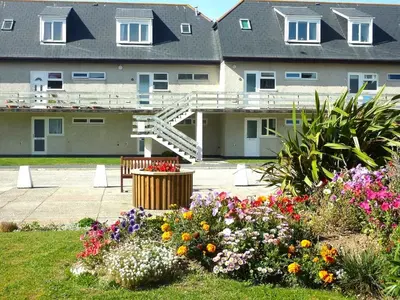 a group of flowers in front of a building at 8 Penhale in Perranporth