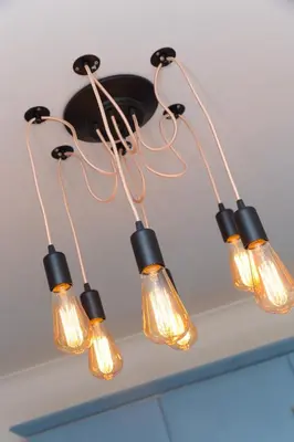 a cluster of lights hanging from a ceiling at SeaBreeze 3 - seaview & Parking in St Ives