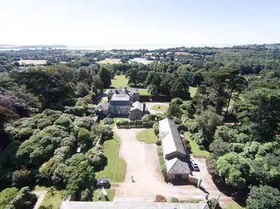 an aerial view of a building in a park at Gamekeeper's Cottage within historic Tregrehan Garden in Par