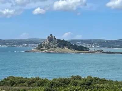 a castle on an island in the water at Pottsville Cabin Sleeps 4 with Deck in Praa Sands