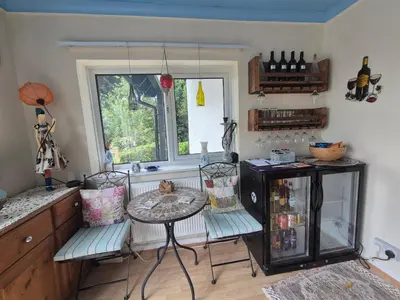 a kitchen with two chairs and a table and a window at Tregarth House in St Austell