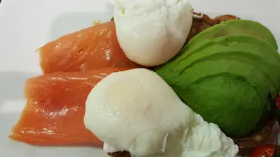 a plate of food with ice cream and fruit at Schooner Point Guest House in Looe