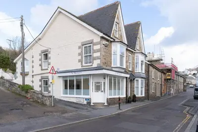 a white building on the corner of a street at Room 2 Hotel style Double bedroom in Marazion in Marazion