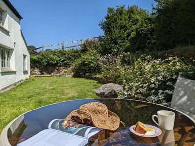 a glass table with a plate of food on it at Foxglove Cottage in Launceston