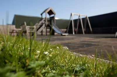 a row of playground equipment in a field of grass at Trevose Golf and Country Club in Padstow