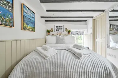 a bedroom with two beds with towels on them at Luxury Couple's Getaway with River Views and Parking in Polperro