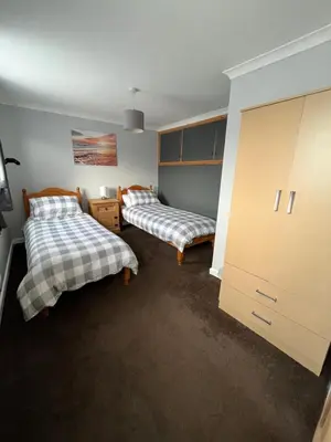 a bedroom with two beds and a large closet at Pet friendly cottage in Pool