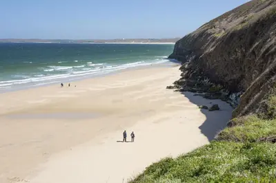 a group of people walking on a beach at Cottage By The Sea, Wi-Fi, Pets Accepted in St Ives