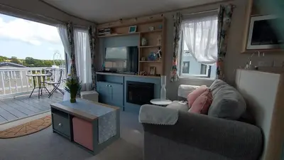 a living room with a couch and a table at Roecliff in St Austell