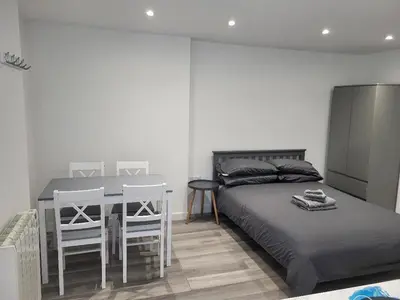 a bedroom with a bed and a table and chairs at The Cosy Nook in Redruth