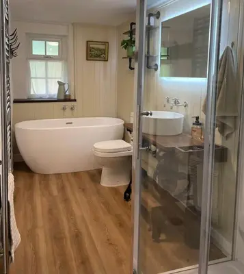 a bathroom with a tub and a toilet and a sink at The Anvil, 2 bed cottage, in the heart of Cornwall in Gwennap