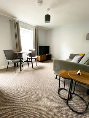 a living room with a couch and a table at Poldice Valley Apartments in Chacewater