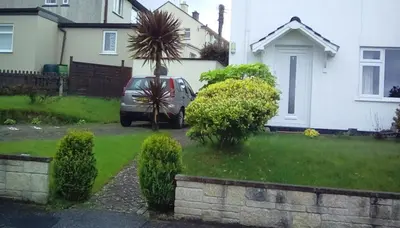 a car parked in the driveway of a house at Bed & Breakfast Only - not 24 hour lodging - Truro, Cornwall - free parking in Truro