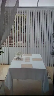 a table on a balcony with a white fence at Bed & Breakfast Only - not 24 hour lodging - Truro, Cornwall - free parking in Truro