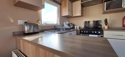 a kitchen with a wooden counter top in a kitchen at NB166 - Porth Bay Hideaway in Porth