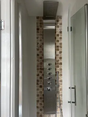 a shower in a bathroom with a glass door at The Captain's House in Looe