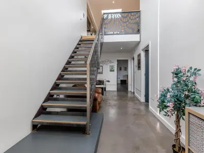 a staircase in a house with a dog laying on the floor at Tregarden in Bude