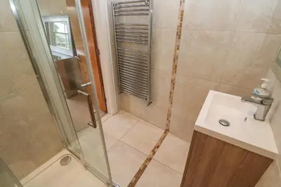 a bathroom with a shower and a sink at The Penthouse in Helston