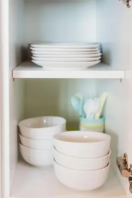 a white shelf with plates and bowls on it at Riverside Retreats - Steamers Meadow in Gwinear