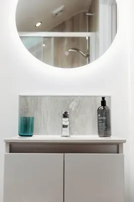 a bathroom counter with a mirror and a sink at Riverside Retreats - Steamers Meadow in Gwinear