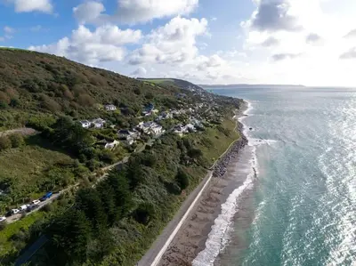 an aerial view of the shoreline of a beach at Mesmerising sea views - Penrose - above the beach Cornwall. in Downderry