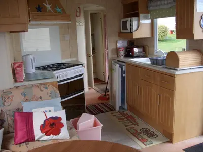 a kitchen with a sink and a stove at Colin and annioes caeravan in Looe