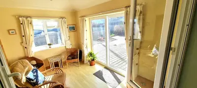 a living room with a sliding glass door at Trenare in Perranporth