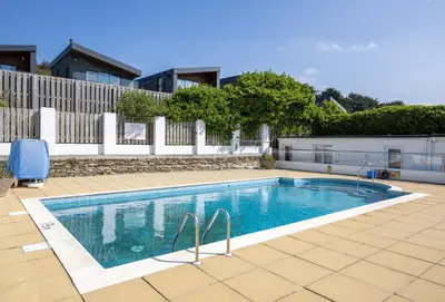 a swimming pool in the backyard of a house at 3 Europa Court in Mawgan Porth in Mawgan Porth