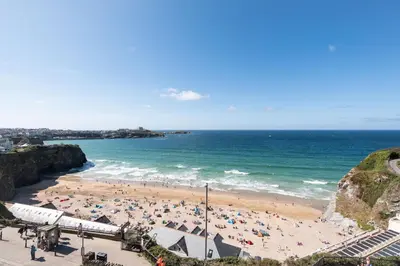 a beach with a crowd of people and the ocean at 41 Tre Lowen in Fistral, Newquay in Newquay