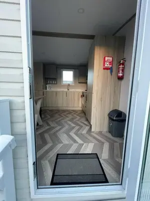 an open door to a room with a kitchen at Two bedroom Holiday home in Newquay