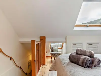 a bedroom with a bed and a large window at 3 Bed in Truro oc-78090 in Porthtowan