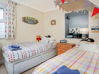 a bedroom with two twin beds and a mirror at Tean in Polruan
