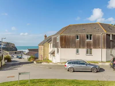 a car parked in a parking lot in front of a house at 2 Bed in Truro oc-86648 in Porthtowan