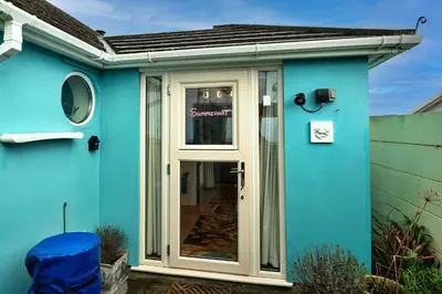 a blue house with a glass door on it at Finest Retreats - Treknow Summerhut in Tintagel