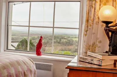 a cat sitting on a window sill in a bedroom at 3 Bed in St. Breward oc-g28144 in Saint Breward